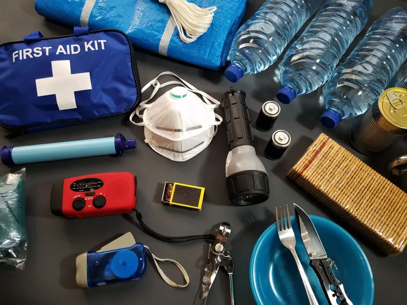 First-aid kit, protective masks and emergency supplies laid out on a table