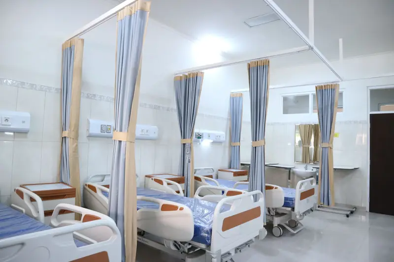 Modern hospital ward with beds and privacy curtains