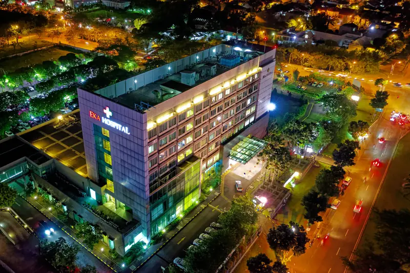 Multi-storey hospital building lit up at night